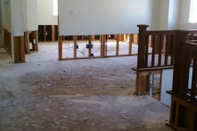 Room with lower drywall removed during a water damage dry-out