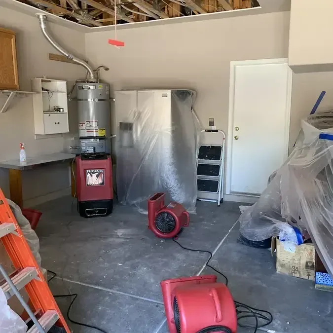 Drying equipment running in a garage with an opened ceiling