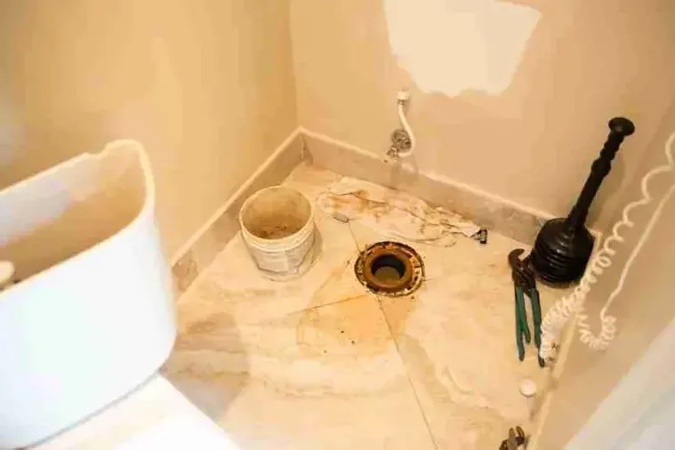 Soiled bathroom floor with the toilet removed after a sewage backup